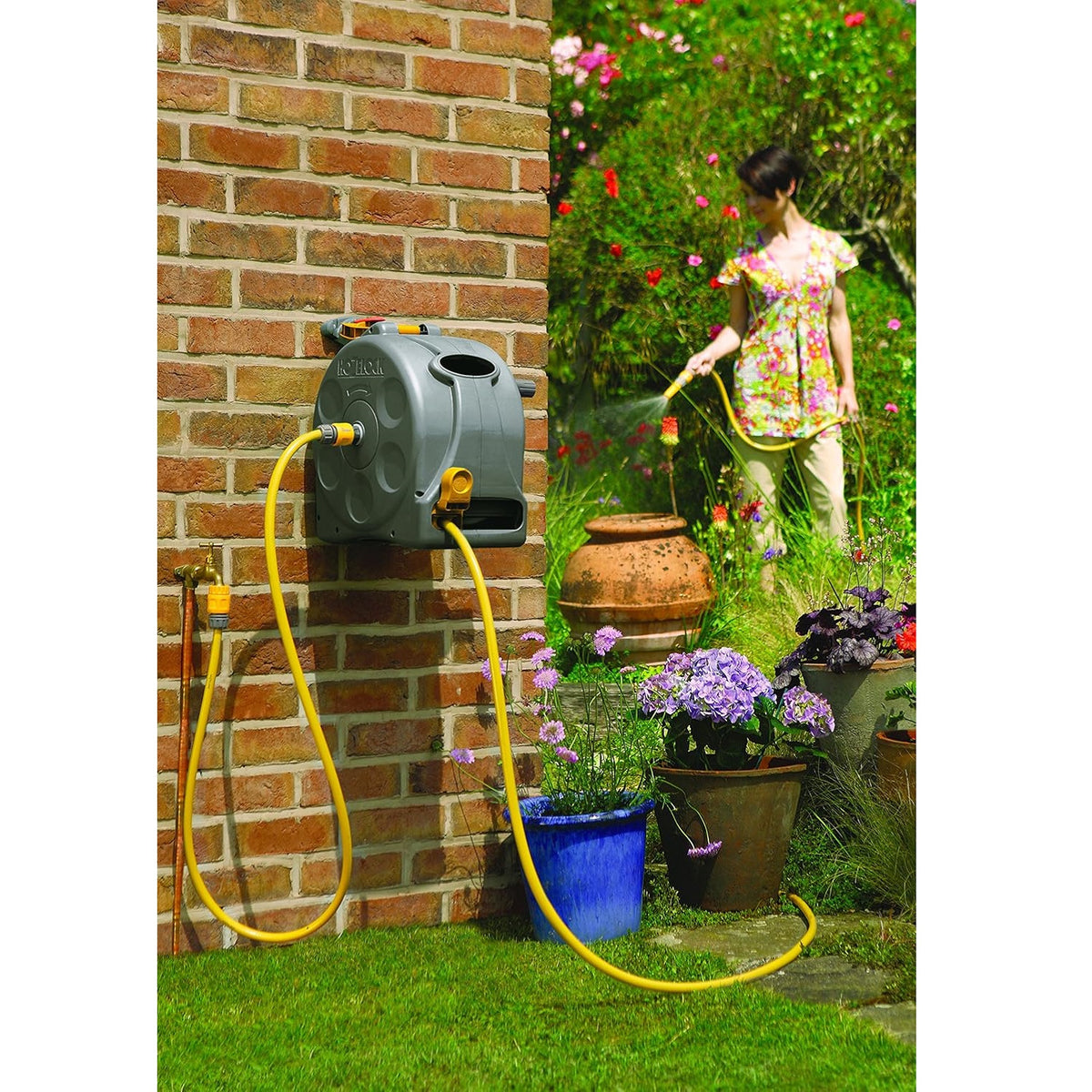 Hozelock 2-in-1 Compact Enclosed Hose Reel Grey Yellow 2415 | With 25Mtr Hose Pipe | Wall Mounted or Free Standing | Ready to Use Manual Rewind Layering System | Garden Patio Lawn Car Wash Watering | Supplied with Complete Fittings